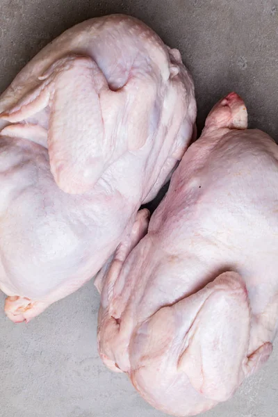 two raw bio chicken on grey background. Top view. Diet food