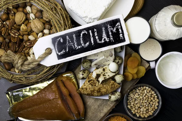 Food rich in calcium such as nuts, milk, peas, lentils, kidney beans, cottage cheese, yogurt, buttermilk, dried apricots, salmon Healthy food Flat lay