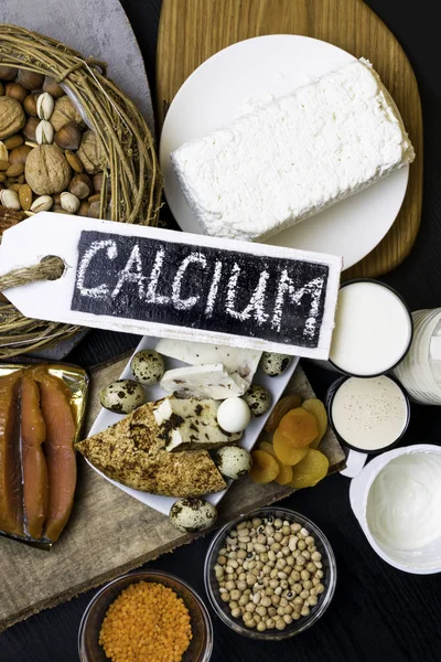 Food rich in calcium such as nuts, milk, peas, lentils, kidney beans, cottage cheese, yogurt, buttermilk, dried apricots, salmonHealthy food Flat lay