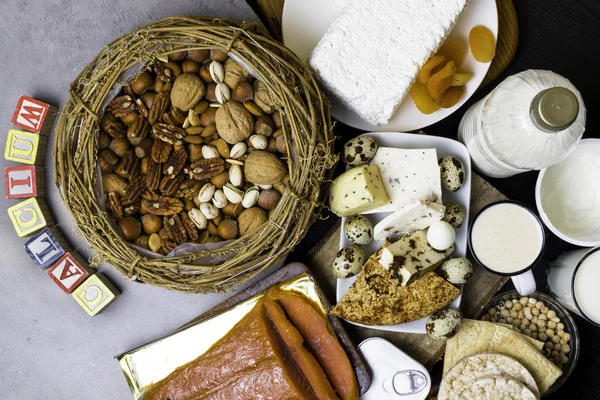 natural food rich in calcium such as nuts, milk, peas, sardines, lentils, kidney beans, cottage cheese, yogurt, buttermilk, biscuits, dried apricots salmon Healthy food Flat lay