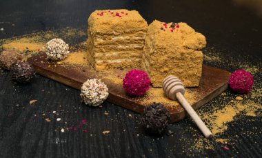 tatlım pasta ve truffeles kaşık bal bir siyah ahşap tablo