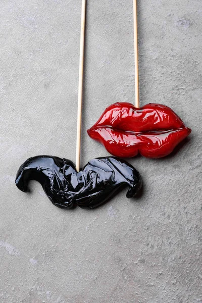 carnival party accessories candy women red lips and man beard on a black background, love concept, man and women, 14th february, weeding