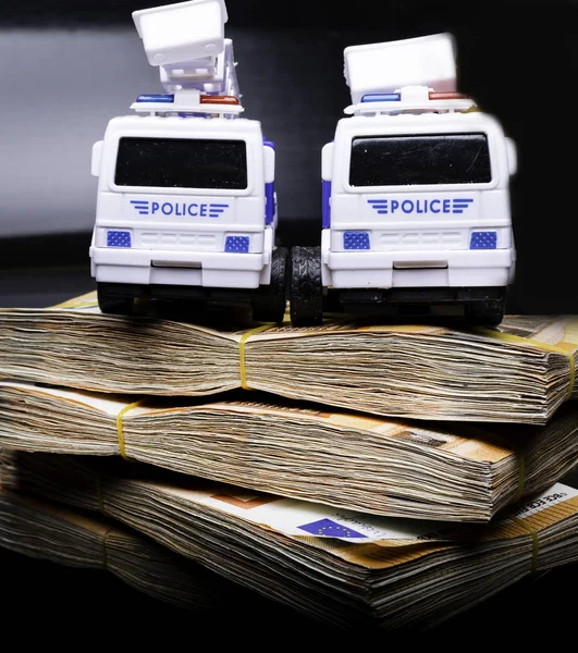 Police corruption in money. Police cars in euros. Crisis in money, bribe and corruption concept