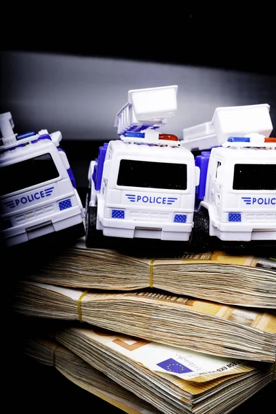 Police corruption in money. Police cars in euros. Crisis in money, bribe and corruption concept