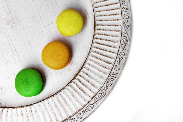 wedding dessert with macaroons on white plate, copy space