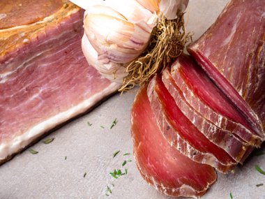 Smoked ham, jerky corned beef on table with garlic Natural product from organic farm, produced by traditional methods