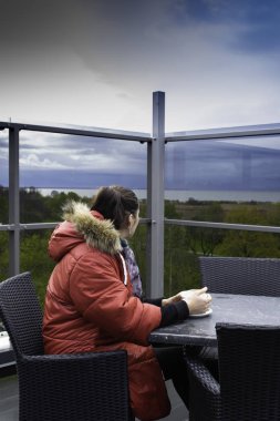 women see the dark time cloud before the storm from veranda, relax time, coffe, tea time outdoor clipart