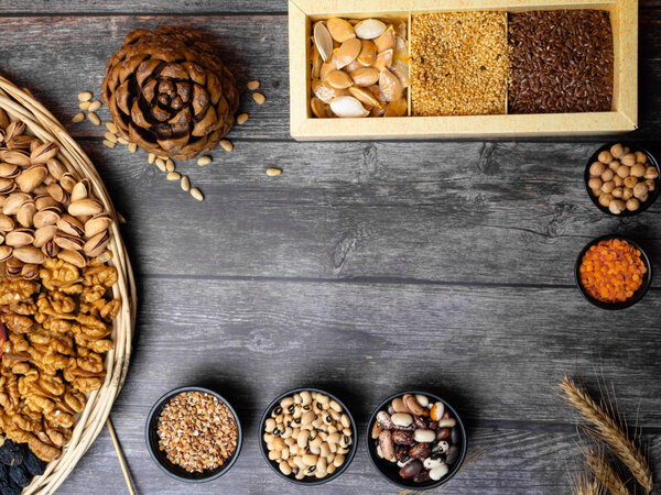 Natural cereal grain food consisted of pistachio, seed, bean for agricultural product concept and carbohydrate food on wooden background