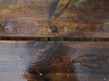 ıslak koyu ahşap yüzeye yansıması ile yağmur yağıyor