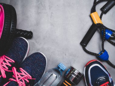 Katta, spor araçları ile rahat spor ayakkabılar kopyalama alanı, spor seti, genişletici, rulo, halter su gri arka plan üzerinde