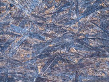 OSB tahtaları ahşap bir zemine zımparalanmış kahverengi odun parçalarından yapılmıştır. OSB ahşap kaplama arka planının üst görünümü, sıkı, pürüzsüz yüzeyler.