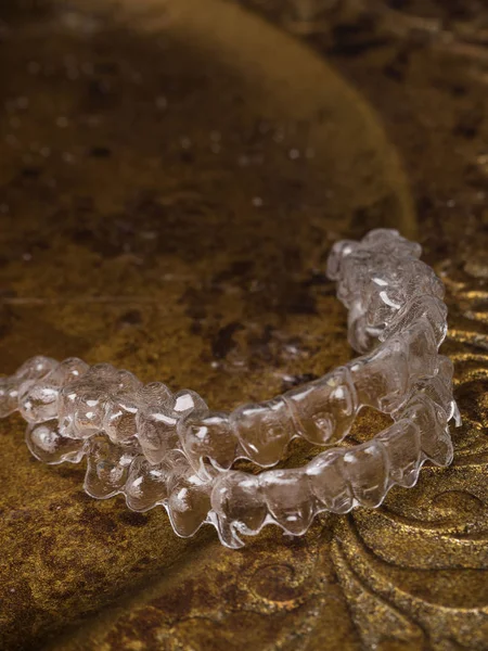 teeth aligners. Invisible brackets on gold plate Shine smile concept