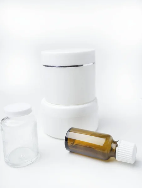 Primer plano del contenedor de higiene de belleza sobre fondo blanco con botellas de vidrio de aceite esencial — Foto de Stock