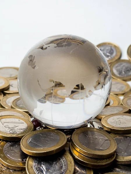 Global economy concept with sphere globe and stacked of coins over white Stock Photo