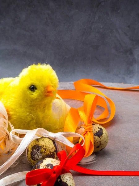 Easter eggs and chickens on grey background