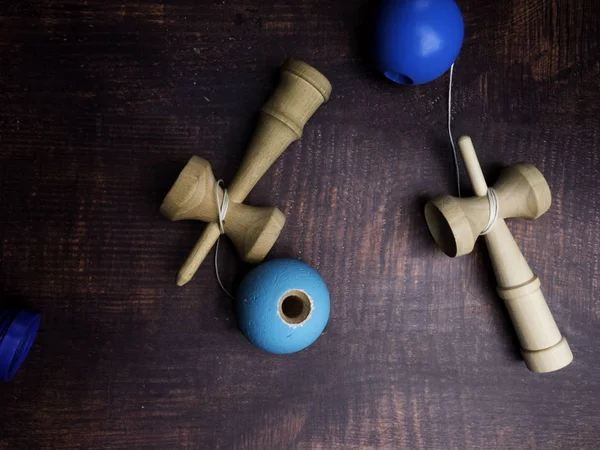 Traditional Japanese wood toy Kendama on wooden background, Symbol of Japanese boy toy.