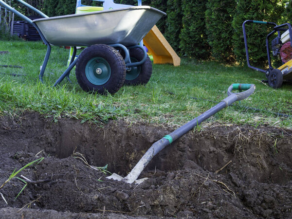 wheel barrow on the land at the county with land and shovel
