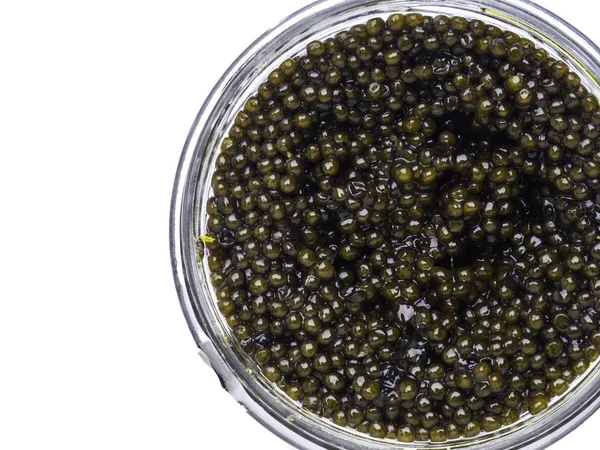 Caviar preto em uma tigela pequena em um fundo branco . — Fotografia de Stock