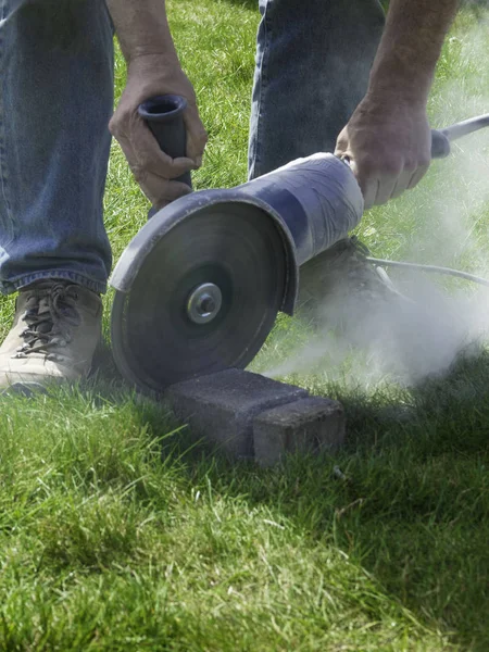 worker Sawing concrete brick outdoor