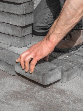 Ev avludrive veranda gri beton döşeme levhalar döşeme. Profesyonel işçi tuğlacı, kaldırım veya veranda tesviye kum temel tabanında.