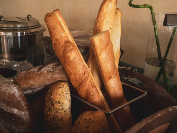 Assortment of baked breads, french baguette on wood box — Stock Photo, Image