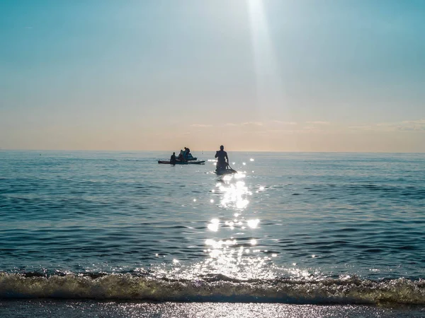 SAP серфинг, люди плавают на доске на воде, активный образ жизни, катамаран и доска — стоковое фото