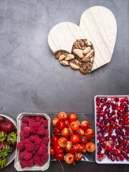 Set of berries, nuts in bowls for a healthy lifestyle. Healthy eating concept, healthy heart food, resveratrol and antioxidants