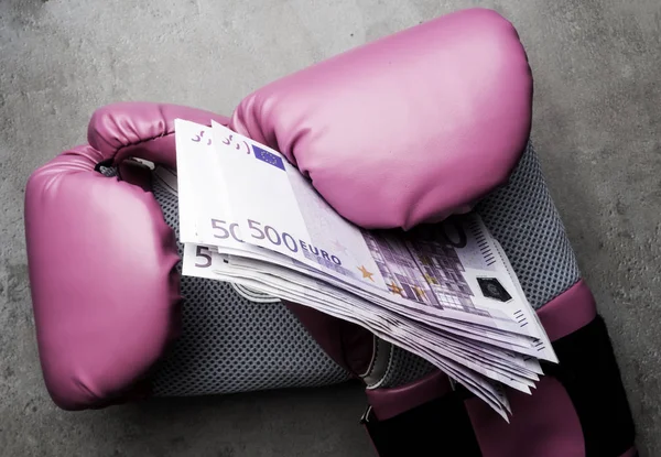 boxing gloves and money. Concept of bribery, dishonesty in sport, greed. Isolated
