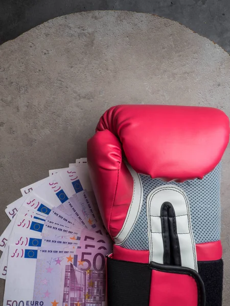 boxing for money, boxing glove with cash, Concept of bribery, dishonesty in sport, greed. Copy space
