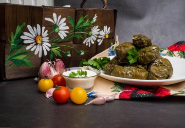 Traditional georgian dolma in grape leaves on rustic wooden table with copyspace clipart