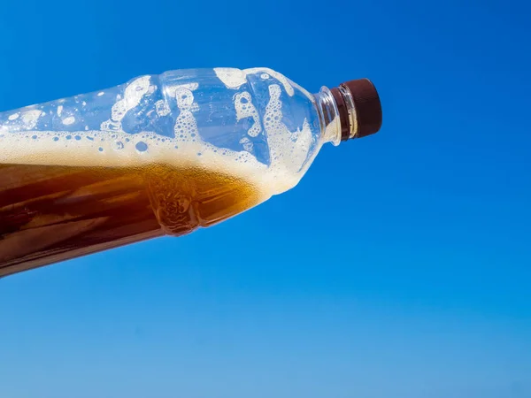 Plastic bottle of drink, beer or kvass, blue sky, global environment conservation concept — Stock Photo, Image