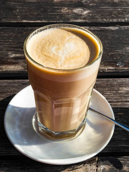 Kawiarnia z kawą Latte Macchiato w wysokiej szklance na drewnianym tle. — Zdjęcie stockowe
