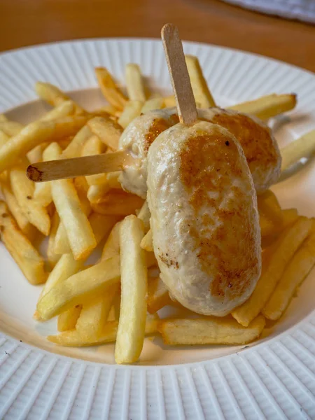 child menu - french fries and chicken cutlets in the form of popsicle