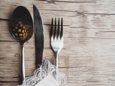 ahşap yüzey, çatal, bıçak, kaşık, kopya alanı ile beyaz fırfırlı peçete ile dekore şenlikli çatal