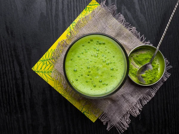 Japanese matcha green tea and matcha green tea powder on wooden table, copy space