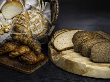 Beton arka planda sepet içinde kulakları ile farklı ekmek
