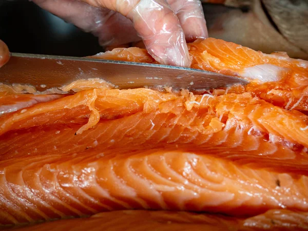 Masabaşında bıçakla balık kesen işçilerin ellerinin kapatılması, seçici odak