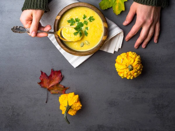 Manos femeninas y calentar la sopa de crema de calabaza otoño con croutons y semillas vegetariano otoño, vegetariano, saludable concepto de alimentación comodidad — Foto de Stock