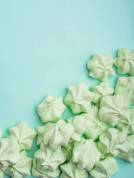 mint green meringues over mint backdrop with copy space