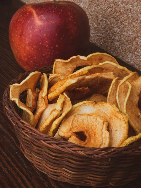 Healthy snack. Homemade dehydrated apple chips on rustic wooden background — Stock Photo, Image