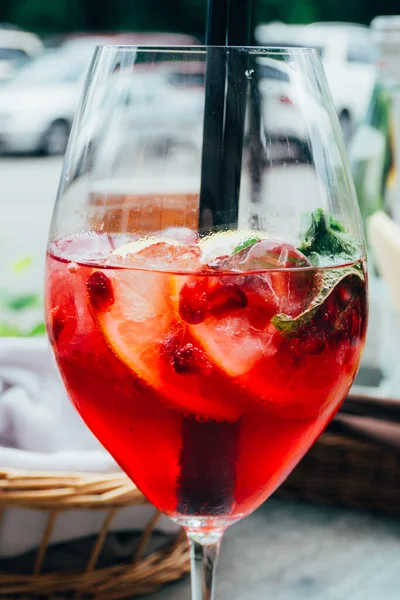 summer cocktail with mint, lemon slices and red berries, Summer refreshing drink. Berry cocktail