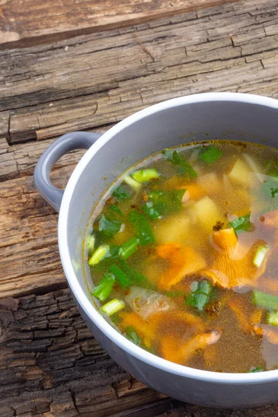 Bowl of soup with autumn chanterelles and herbs, green onion on rusrtic wooden background. Vegetarian Russian cuisine — Stock Image Bowl Soup Autumn Chanterelles Herbs Green Onion Rusrtic Wooden Background Stock Picture
