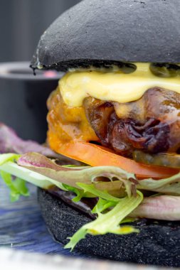 Etli, ekmekli, marullu, peynirli, ketçaplı modern lezzetli siyah burger. Funk gıda konsepti