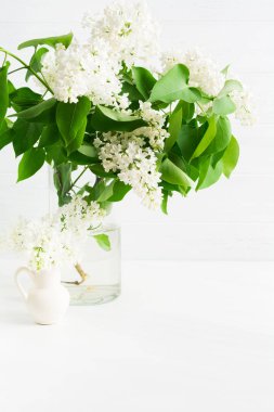 Küçük seramik kavanoz ve çiçekli Beyaz Leylak kopya alanı, yüksek anahtar ile büyük cam vazo