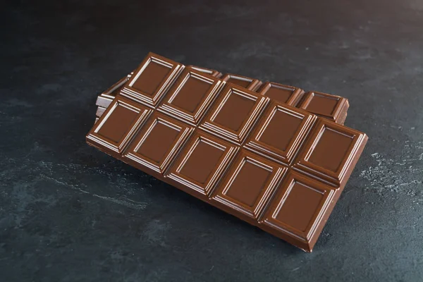 A bar of chocolate over black background with copy space