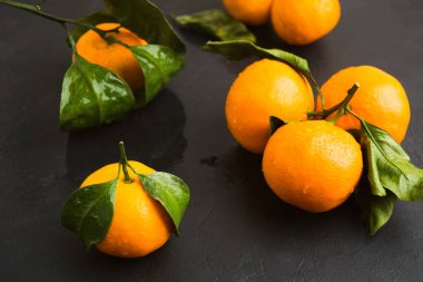 Siyah arka plan, seçici odak üzerinde taze ıslak mandalina