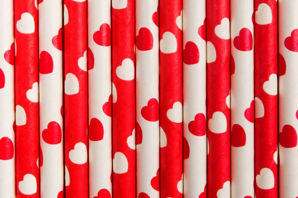 Red and white paper straws eco-friendly background with hearts, ecology love concept texture