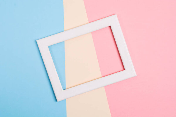Colorful paper background with white wooden frame