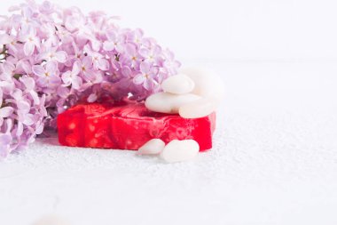Beyaz taşlar ve leylak çiçekleri ile Hanmade sabun. Spa ve aromaterapi konsepti