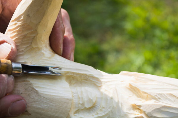 Old man hands with cutter for wood carving. Handmade concept